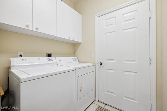 washroom with cabinet space and washing machine and clothes dryer