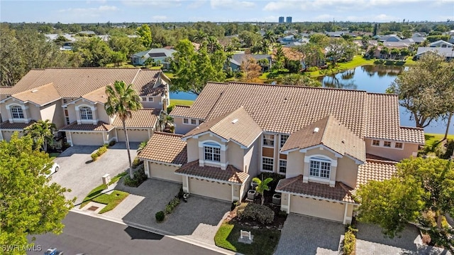 birds eye view of property with a residential view and a water view