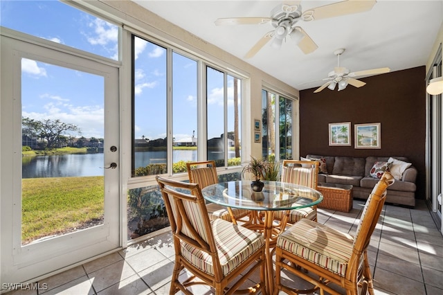 sunroom featuring a water view, a healthy amount of sunlight, and ceiling fan