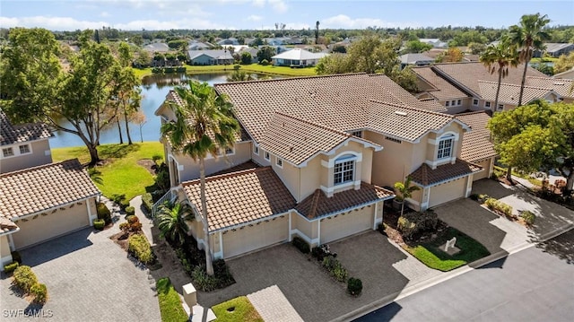 drone / aerial view featuring a residential view and a water view