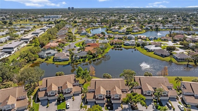 drone / aerial view with a residential view and a water view