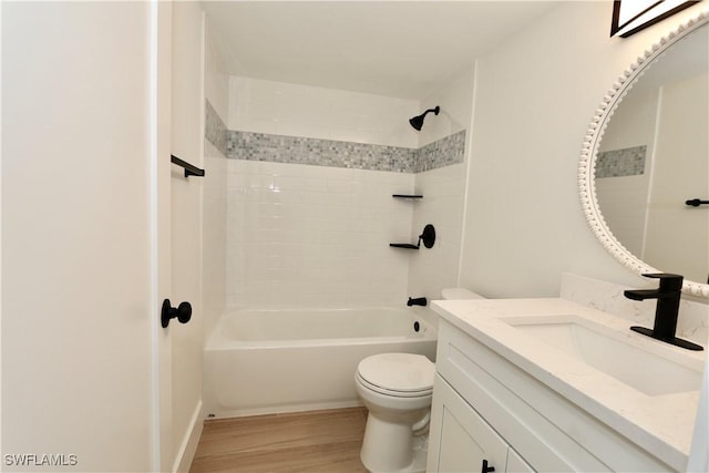 full bathroom featuring vanity, toilet, wood finished floors, and tub / shower combination