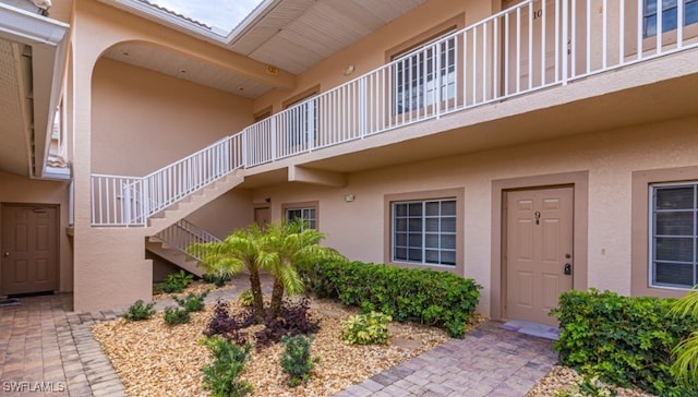 view of exterior entry with stucco siding