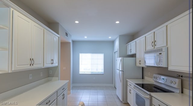 kitchen with light countertops, recessed lighting, light tile patterned flooring, white appliances, and white cabinetry