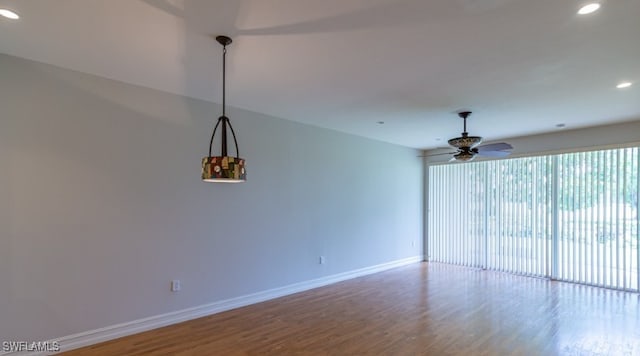 empty room with recessed lighting, wood finished floors, baseboards, and ceiling fan