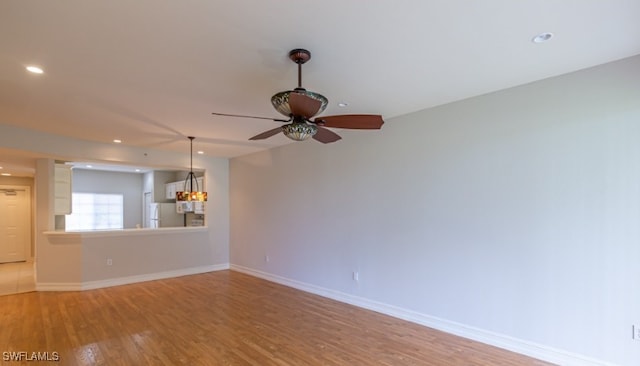 unfurnished living room featuring a ceiling fan, recessed lighting, baseboards, and light wood finished floors