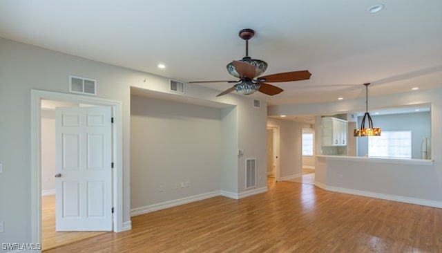 unfurnished living room featuring recessed lighting, visible vents, baseboards, and light wood-style flooring