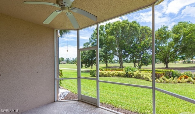 unfurnished sunroom featuring ceiling fan