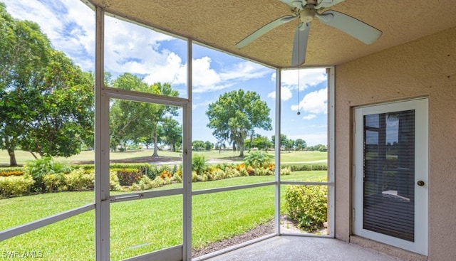 unfurnished sunroom with a ceiling fan