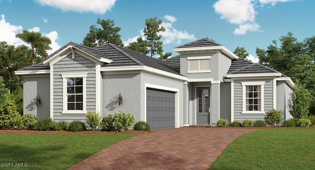 view of front facade featuring stucco siding, a front lawn, decorative driveway, and a garage