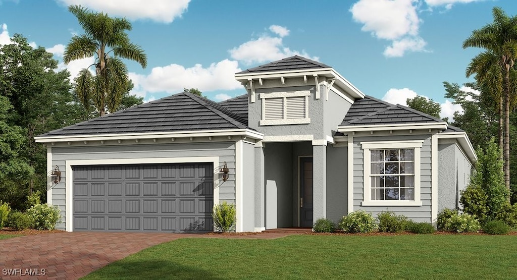 view of front of house with a garage, decorative driveway, and a front yard