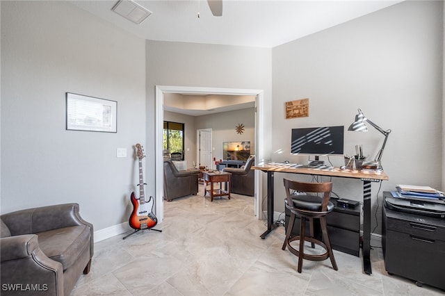 office space featuring visible vents, baseboards, and ceiling fan