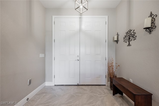 doorway to outside with baseboards