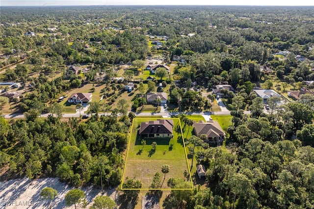 aerial view featuring a view of trees and a residential view