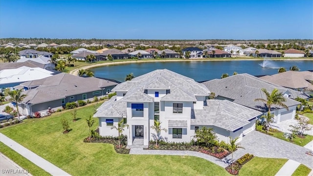 drone / aerial view featuring a residential view and a water view