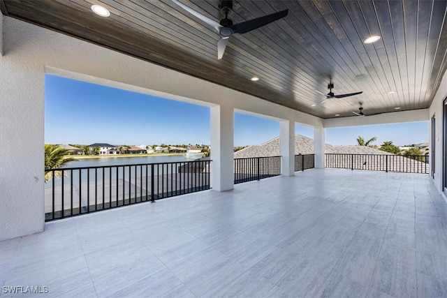 view of patio featuring a water view and a ceiling fan