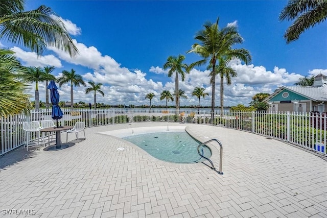 view of pool with a patio, a swimming pool, and fence