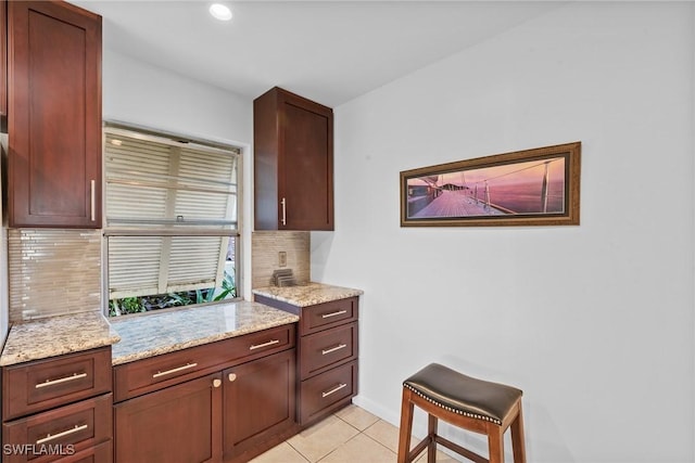 2032 Bahama Ave, Fort Myers, FL 33905 - kitchen with light tile patterned flooring, baseboards, recessed lighting, tasteful backsplash, and light stone counters