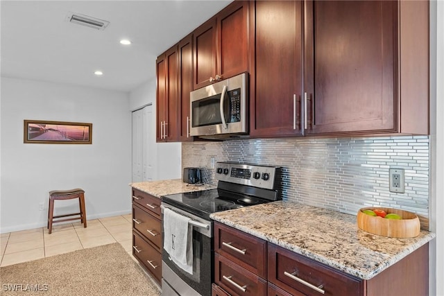 2032 Bahama Ave, Fort Myers, FL 33905 - kitchen with tasteful backsplash, light stone countertops, appliances with stainless steel finishes, light tile patterned floors, and visible vents