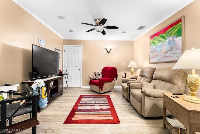 living room featuring light wood-type flooring, visible vents, ceiling fan, and crown molding