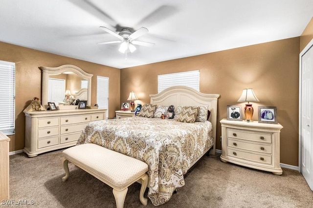 bedroom featuring a ceiling fan, light colored carpet, and baseboards