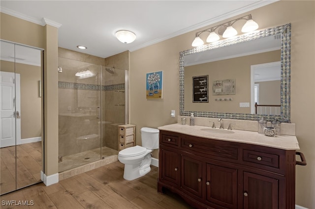 bathroom featuring wood finished floors, ornamental molding, and a shower stall