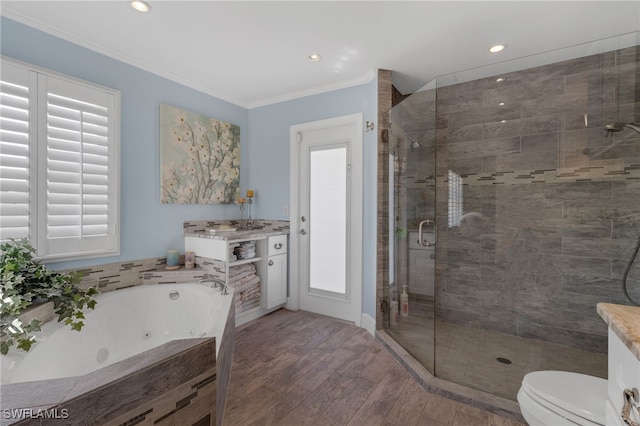 full bath featuring a jetted tub, crown molding, toilet, a stall shower, and wood finished floors