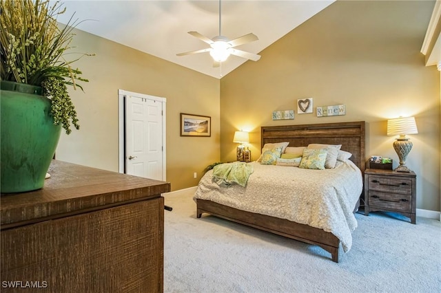 bedroom with baseboards, carpet floors, high vaulted ceiling, and a ceiling fan