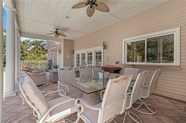 view of patio with outdoor dining space and a ceiling fan