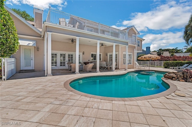 view of pool with a patio, french doors, fence, and ceiling fan