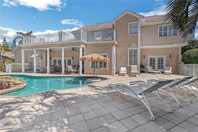 pool featuring a ceiling fan, a patio, french doors, and fence