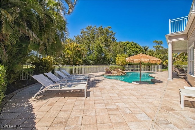 view of swimming pool with a fenced in pool and a patio