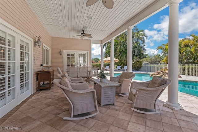 view of patio / terrace featuring french doors, a fenced in pool, ceiling fan, and fence