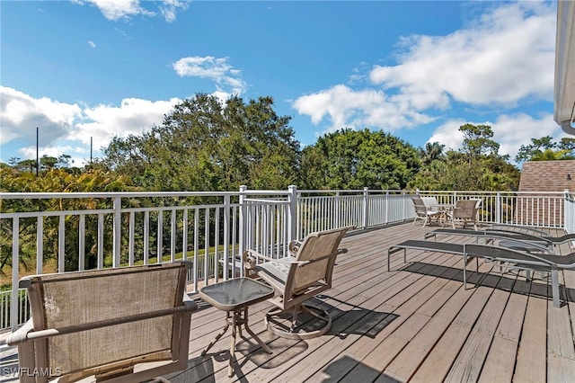 wooden terrace with outdoor dining space