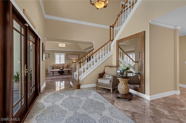 foyer entrance with crown molding, french doors, stairs, and baseboards