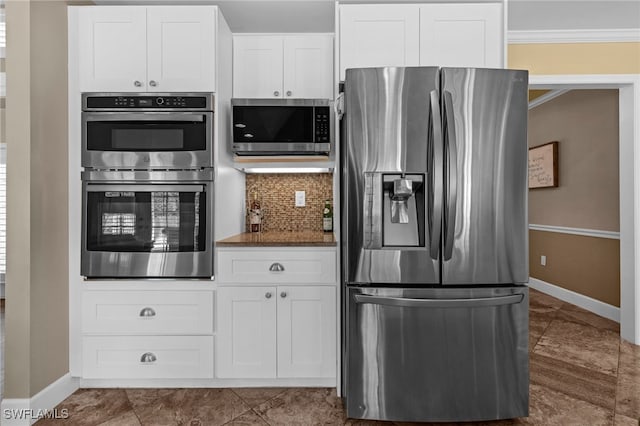 kitchen featuring tasteful backsplash, appliances with stainless steel finishes, ornamental molding, and white cabinets