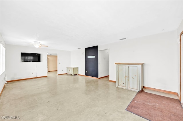 unfurnished living room with visible vents, baseboards, concrete flooring, and ceiling fan