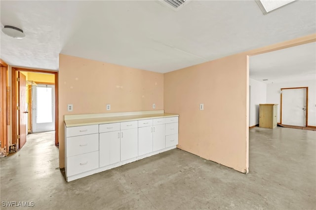 empty room with visible vents and concrete flooring