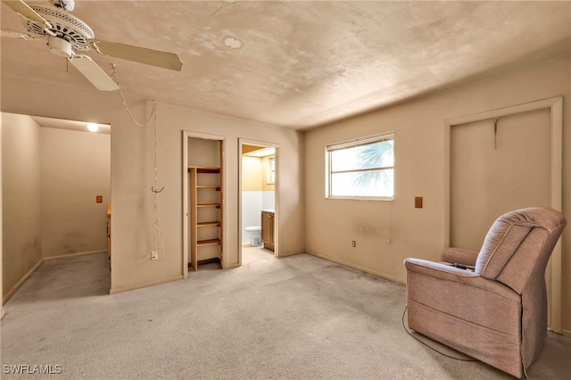 unfurnished room with light colored carpet and a ceiling fan