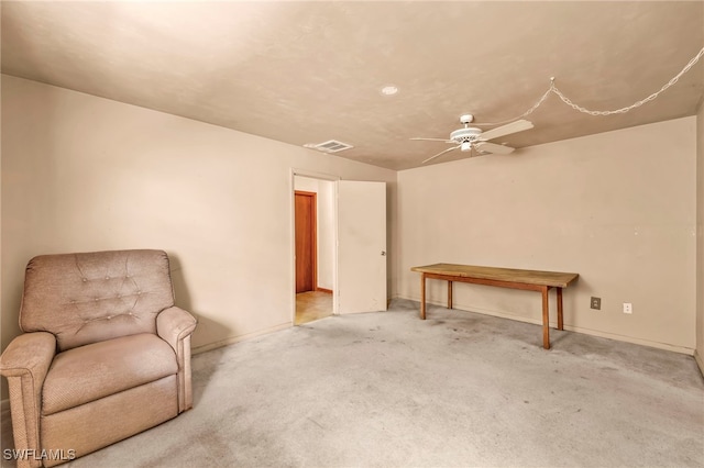 living area featuring visible vents, carpet floors, baseboards, and ceiling fan