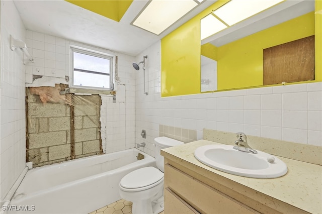 full bath featuring shower / bathing tub combination, toilet, tile walls, and vanity