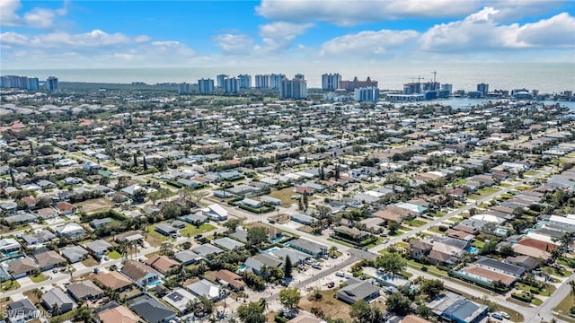 birds eye view of property featuring a city view and a water view