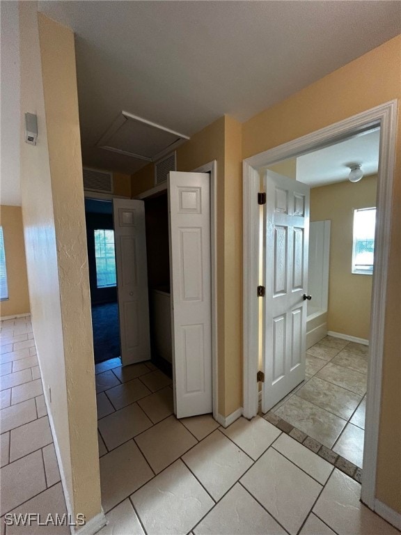 1926 NE 15th Ln, Cape Coral, FL 33909 - hall with light tile patterned flooring, visible vents, attic access, and baseboards