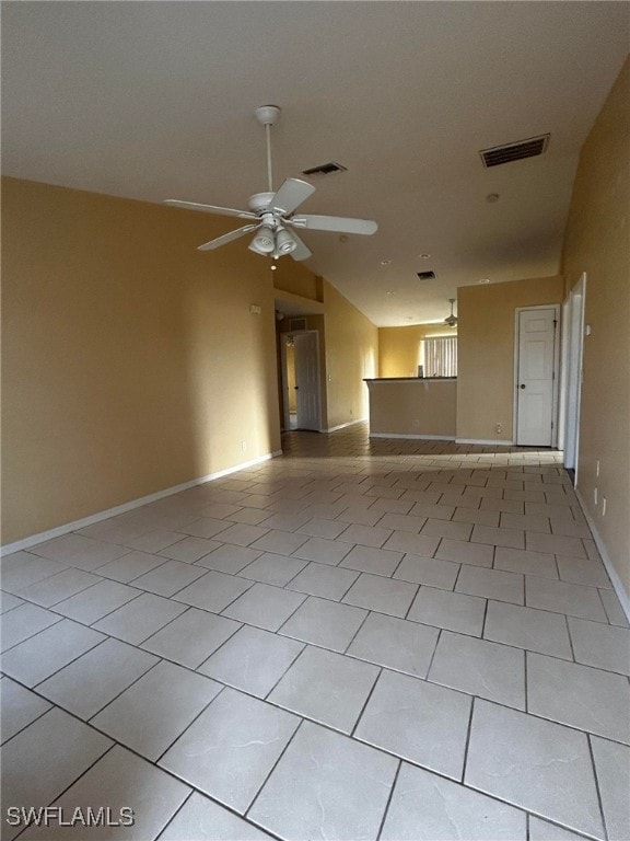 1926 NE 15th Ln, Cape Coral, FL 33909 - unfurnished living room with light tile patterned floors, visible vents, a ceiling fan, and vaulted ceiling