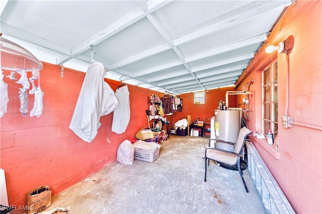 interior space with water heater and concrete block wall