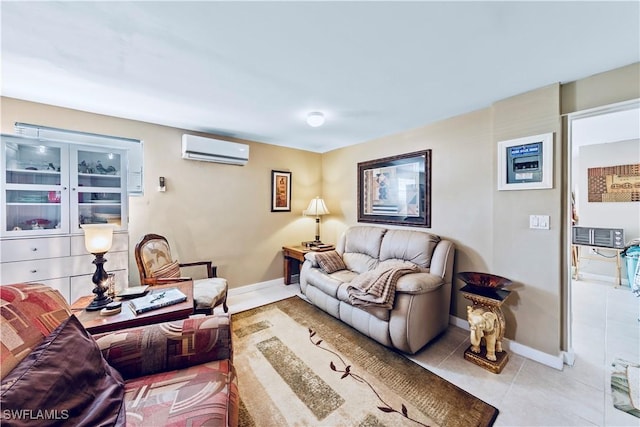 living area with a wall mounted air conditioner, baseboards, and tile patterned floors