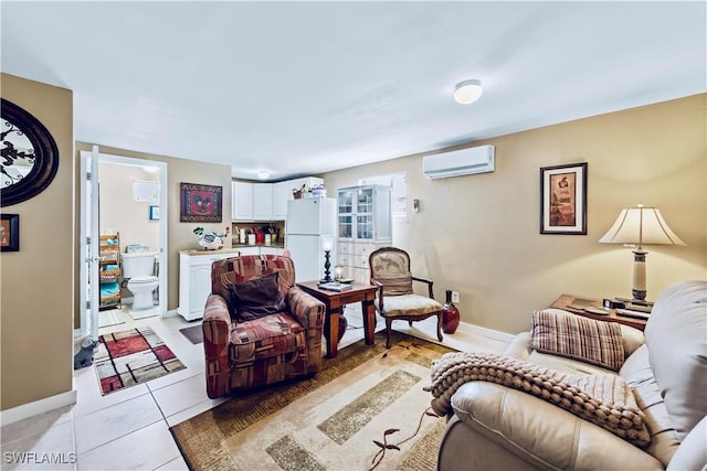 living area featuring light tile patterned floors, baseboards, and a wall unit AC