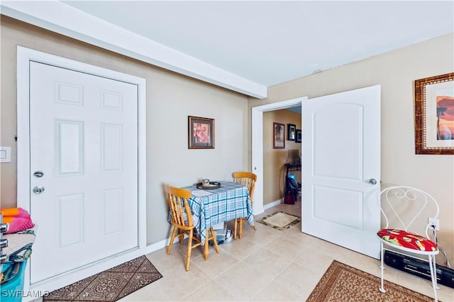 dining space with light tile patterned floors and baseboards