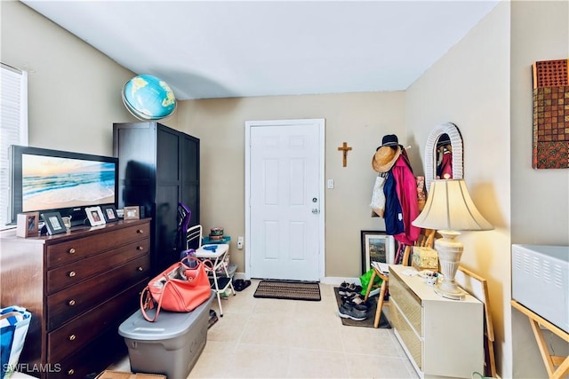 interior space with tile patterned floors and baseboards