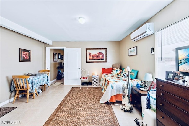 bedroom with a wall mounted air conditioner, baseboards, and light tile patterned floors